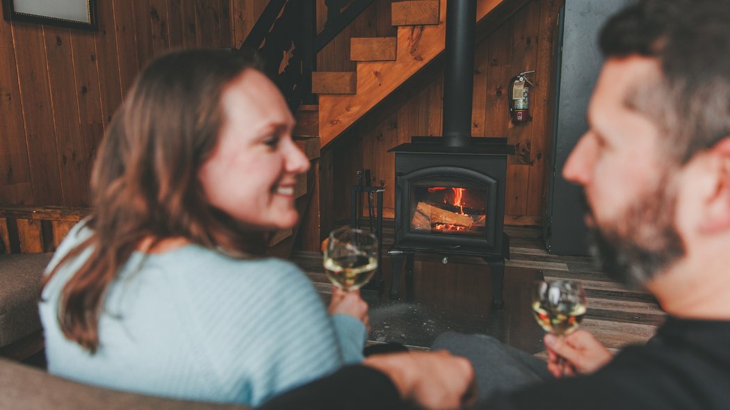 A couple in front of a fireplace