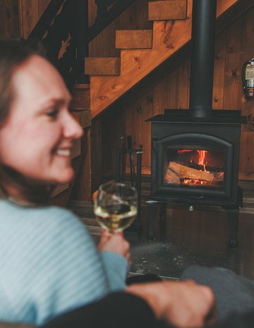 A couple in front of a fireplace