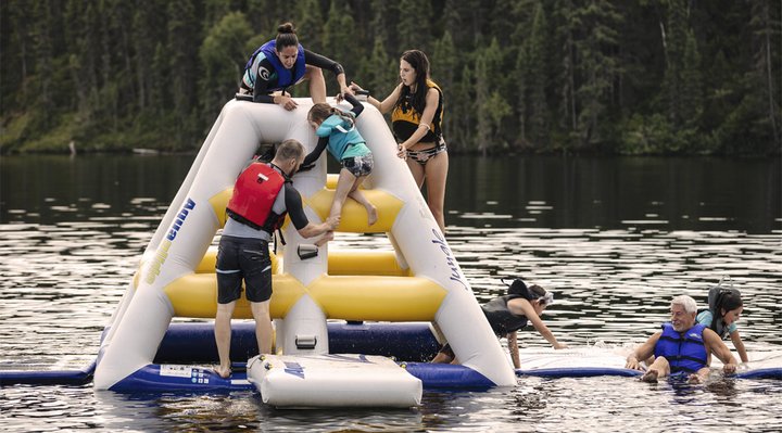 A group playing in a play module on the water