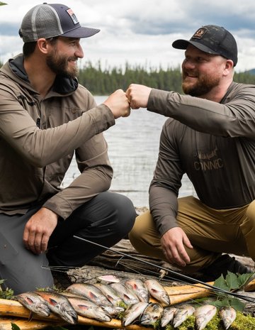 Two men congratulating each other on their fish