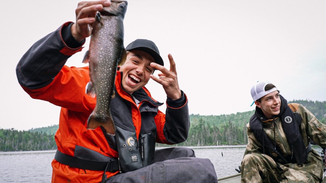 Two young men with a trout