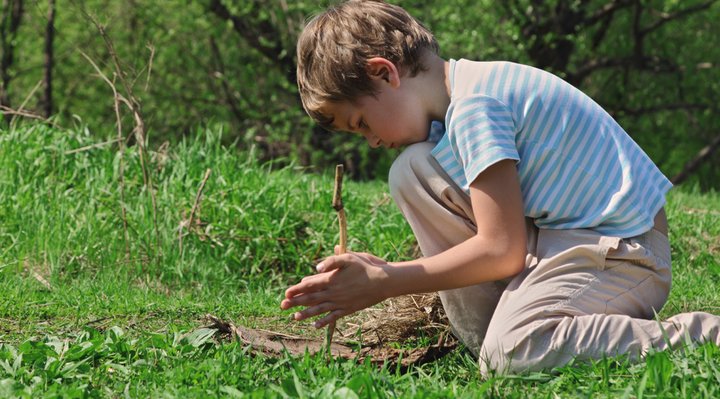 A child trying to make fire