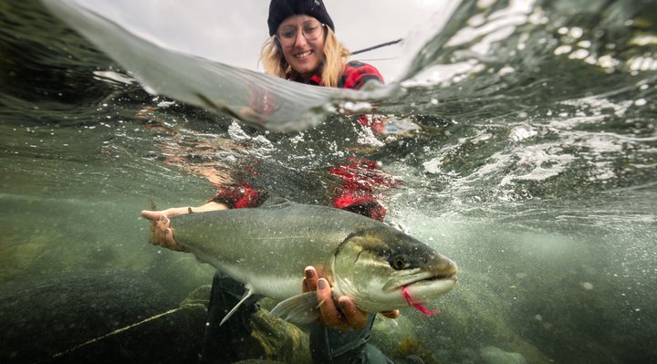 Underwater view of a fisherwoman and her fish.