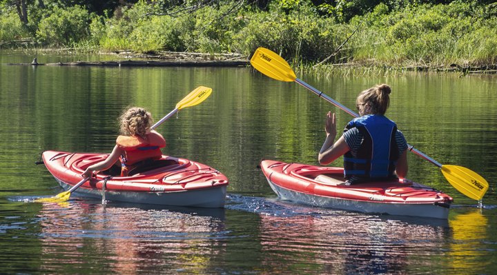 Two people on the water in a kayak.