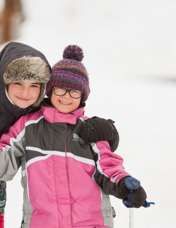 Two children snowshoeing in outfitters 