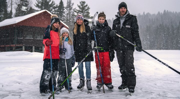 A family skating on the lake