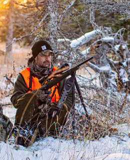 José Boily hiding in a snowy woodland, hunting white-tailed deer.