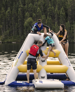 A family playing on a lake.