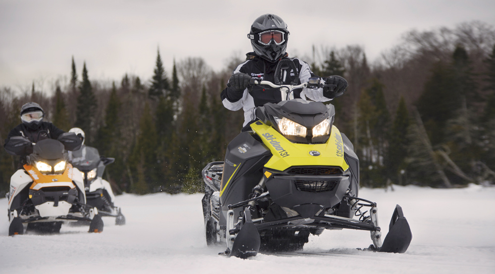 Two people on a snowmobile 