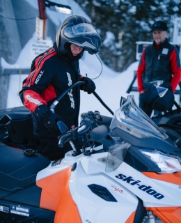 A man filling up his snowmobile with gas