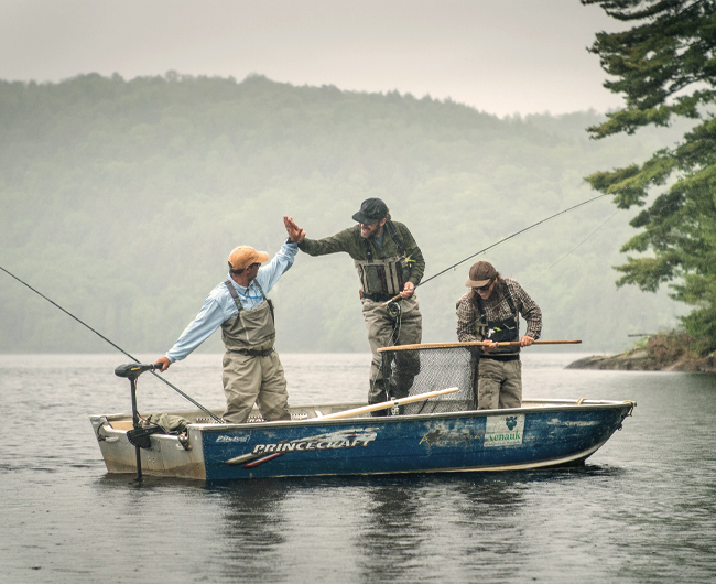 Three fishermen in a rowboat.