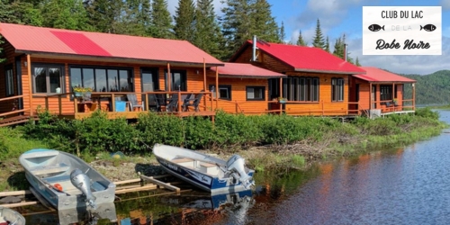 Waterfront cottages with boats and Club de la Robe Noire logo