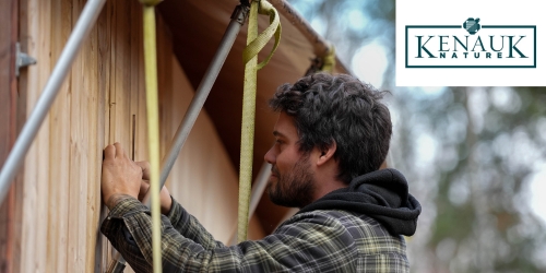 A carpenter nailing with Kenauk logo