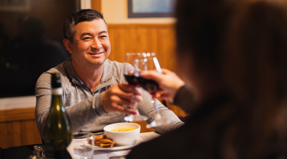 A couple sharing a glass of wine