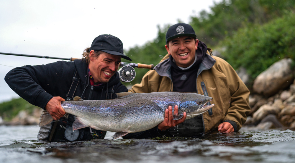 Two fishermen with a salmon